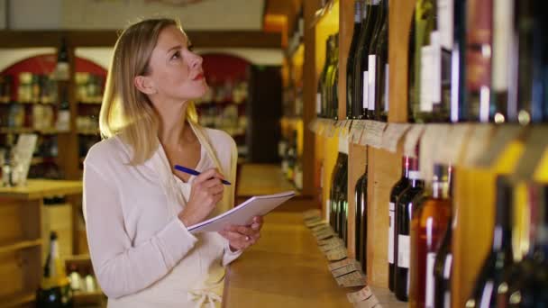 Shopkeeper checking  stock in wine store — Stock Video