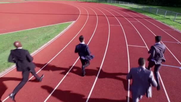 businessmen racing each other at running track
