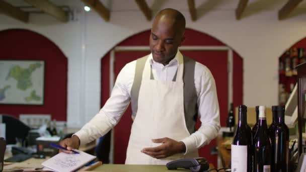 Shopkeeper standing behind the counter — Stock Video