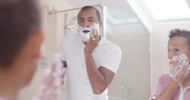 Father and son in bathroom in the morning