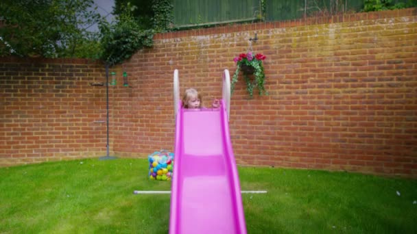 Girl playing on a slide — Stock Video
