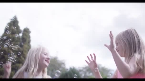 Girls playing with bubbles — Stock Video