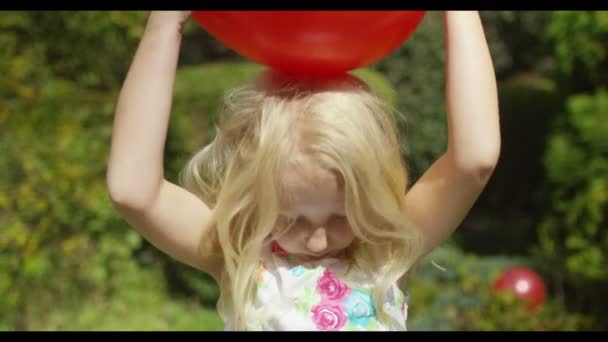 Menina brincando com um balão — Vídeo de Stock