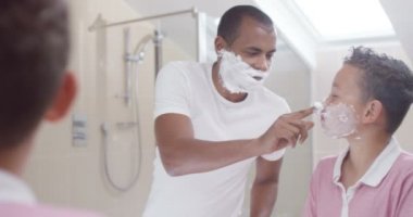 Father and son in bathroom in the morning