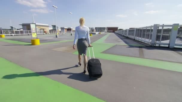 Mujer de negocios caminando con el equipaje en el aeropuerto — Vídeos de Stock