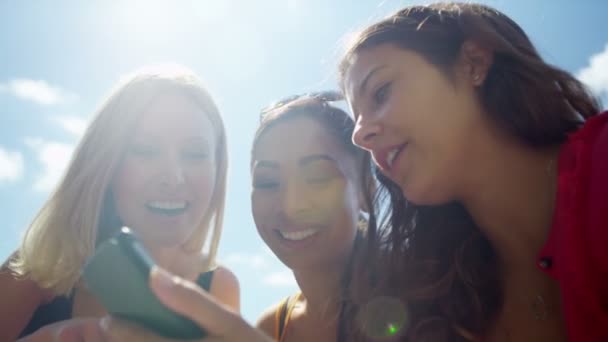 Amigos femeninos mirando el teléfono móvil — Vídeo de stock