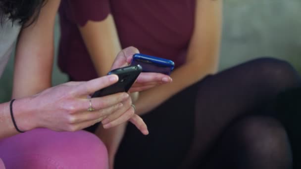 Vrouwelijke vrienden kijken naar mobiele telefoon — Stockvideo