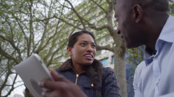 Couple using computer tablet outdoors — Stock Video