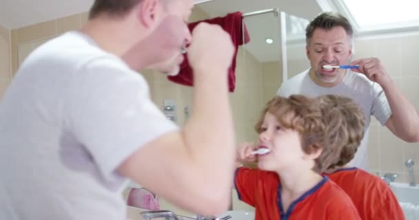 Padre e hijo cepillándose los dientes — Vídeo de stock