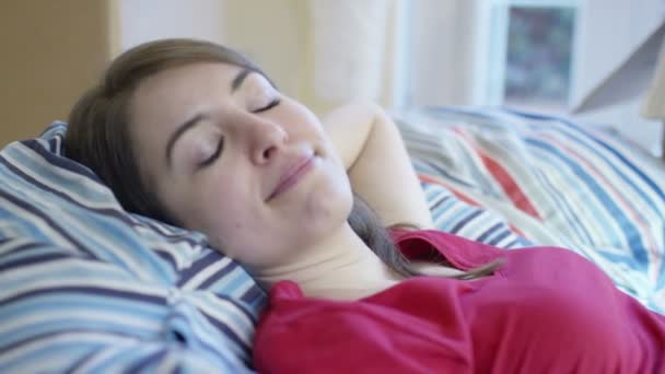 Woman lies down amongst boxes in home — Stock Video