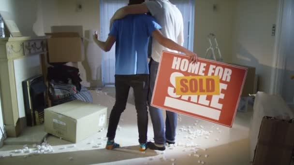 Gay couple standing with 'sold' sign — Stock Video