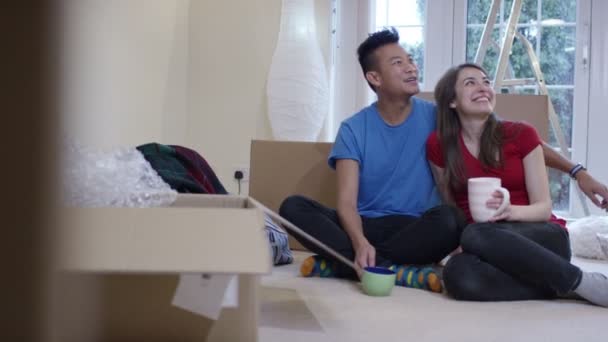 Ehepaar macht Kaffeepause beim Auspacken von Kartons — Stockvideo