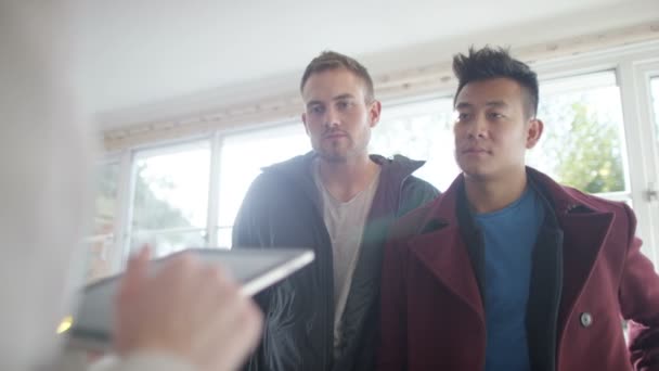 Gay couple with real estate agent looking at home — Stock Video