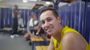 spor salonu soyunma odasında oturan gülümseyen adam