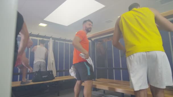 Sports players getting changed in locker room — Stock Video