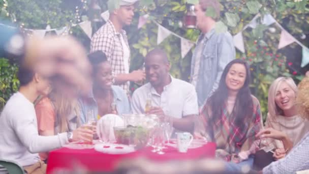 Friends raise beer bottles for a toast — Stock Video