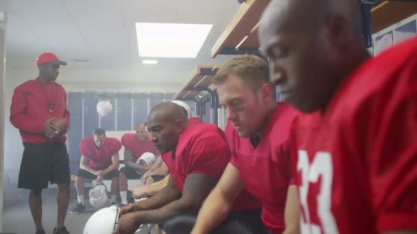 American football player in team locker room — Stock Video