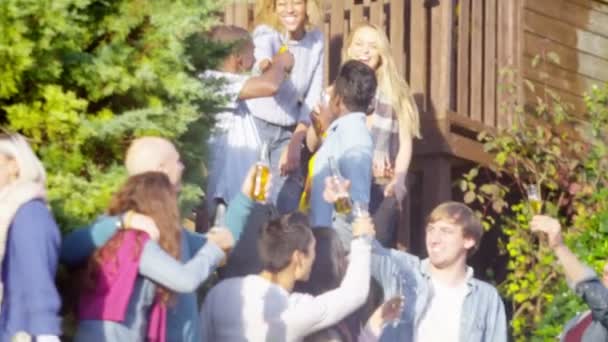 Friends raise beer bottles for a toast — Stock Video