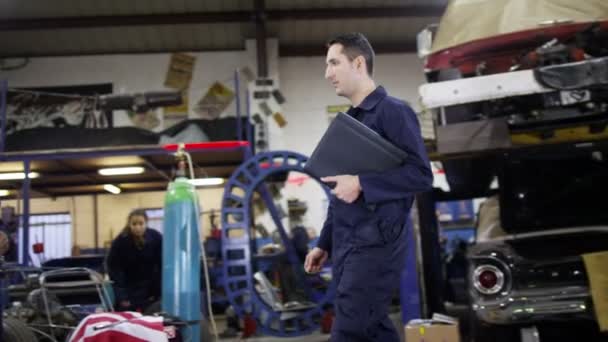 Mechanics in garage workshop — Stock Video