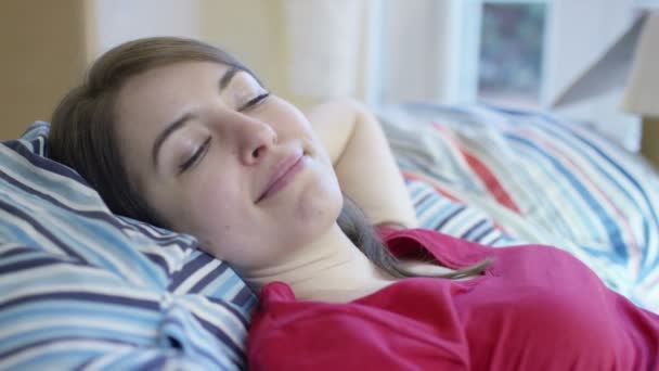 Woman lies down amongst boxes in home — Stock Video