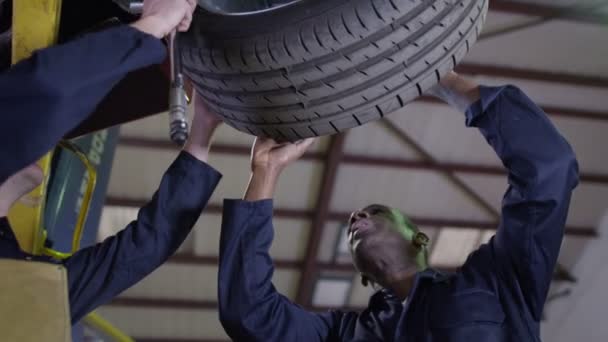Mechanics working underneath a car — Stock Video