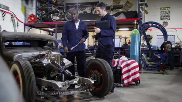 Mechanics working in garage workshop — Stock Video