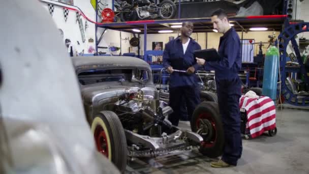 Mechanics working in garage workshop — Stock Video