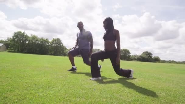 Man and woman stretching-out in — Stock Video