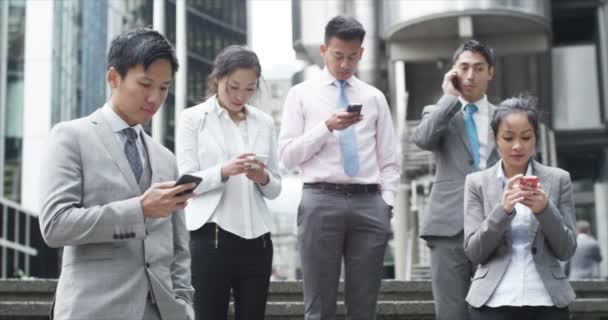 Business group texting on mobile phones — Stock Video