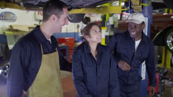 Smiling mechanics in garage workshop — Stock Video