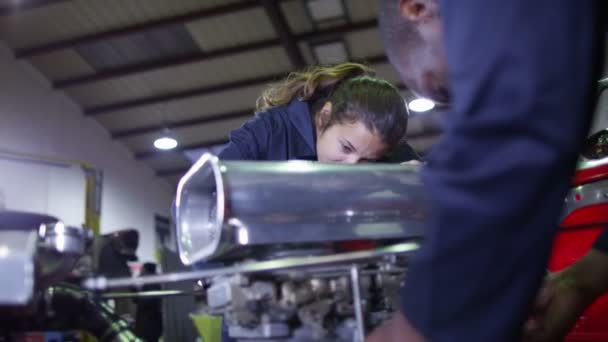 Mechanics working on a car engine — Stock Video