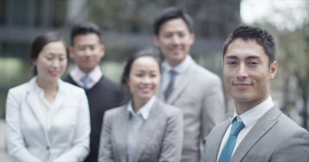  smiling Asian businessman outdoors