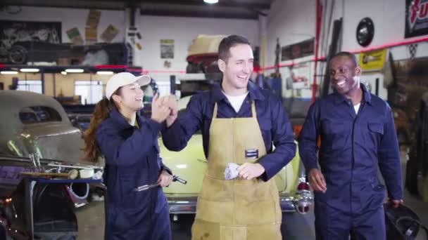 Team of mechanics in garage workshop — Stock Video