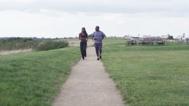 Homme et femme jogging dans le parc — Video