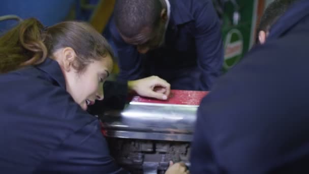 Mechanics working on a car engine — Stock Video