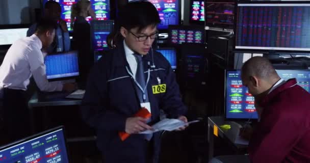 Pénzügyi kereskedők a világ piacain néz — Stock videók