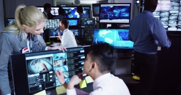 Surveillance team working in control room — Stock Video