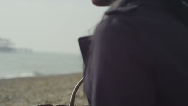 Woman looking out over the sea — Stock Video