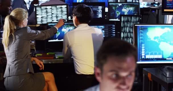 Surveillance team working in control room — Stock Video