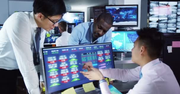 Corretores assistindo os mercados mundiais na sala de negociação — Vídeo de Stock