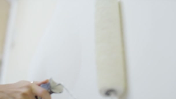 Женщина рисует стену в доме — стоковое видео