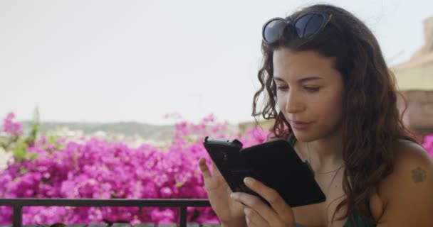 Woman with smartphone outdoors — Stock Video