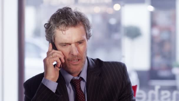 businessman hangs up someone during phone conversation