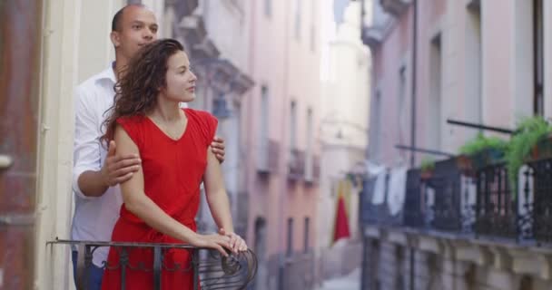 Couple go out onto the balcony — Stock Video