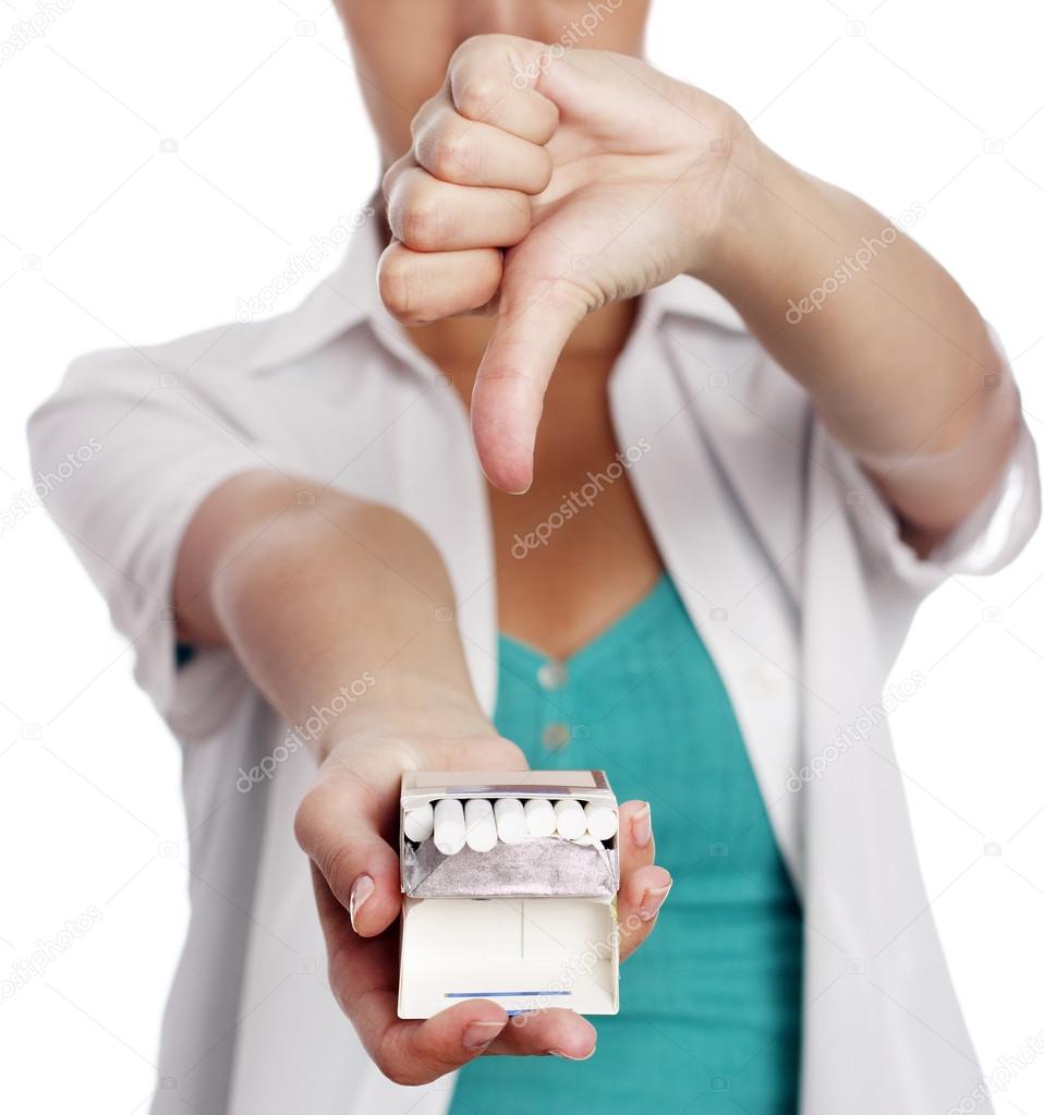 Woman holding cigarettes and showing thumb down