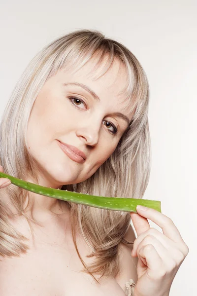 Young beautiful woman with aloe — Stock Photo, Image