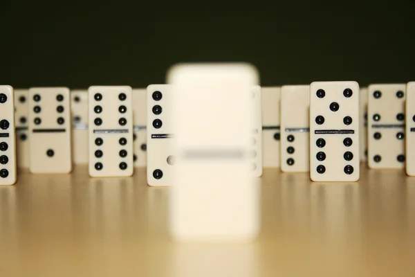 Close up picture of dominos, one from the crowd — Stock Photo, Image