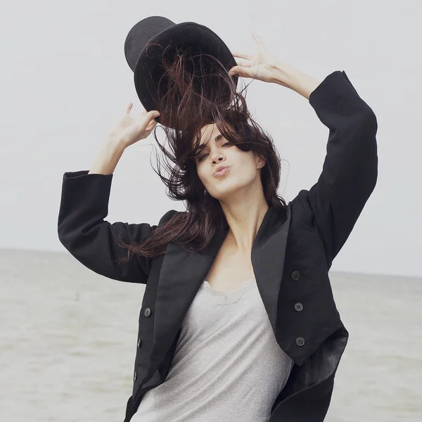 Happy woman wears black cylinder and tail coat — Stock Photo, Image