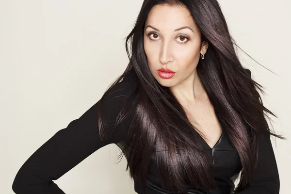 Portrait of sexy beautiful young woman in black leather dress — Stock Photo, Image