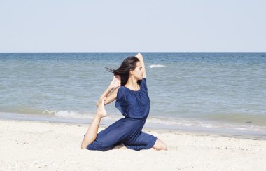 Deniz mavi elbiseli, yoga yaparken genç güzel kadın